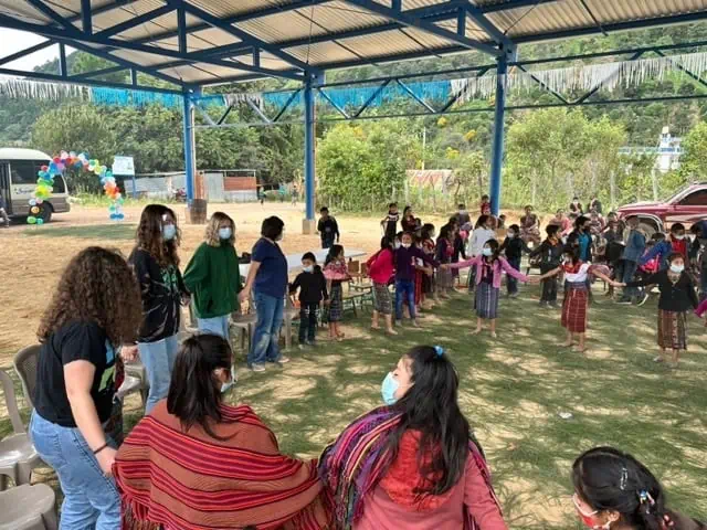 On their Guatemala service trip. Students and local children playing "red-light green-light" and "Duck, Duck, Goose" outside