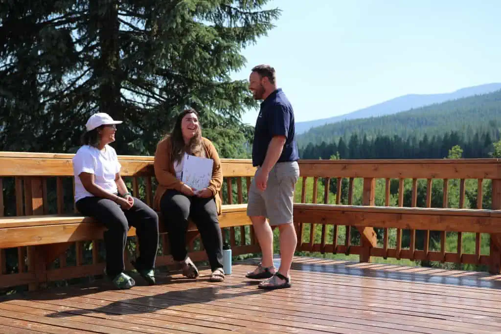 Teens at Turning Winds laughing and speaking with a counselor in a beautiful setting. Turning Winds offer Comprehensive Care for Mental Health and Substance Use